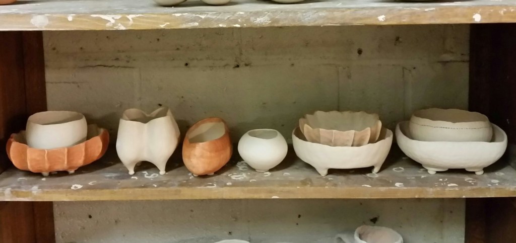 Bonsai pots with wadding on their feet, waiting to be loaded in the wood-fire kiln.